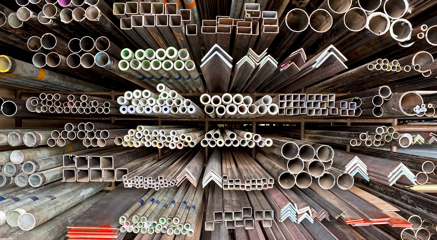 A large pile of steel pipes and tubes stacked together, showcasing various sizes and lengths for construction use.